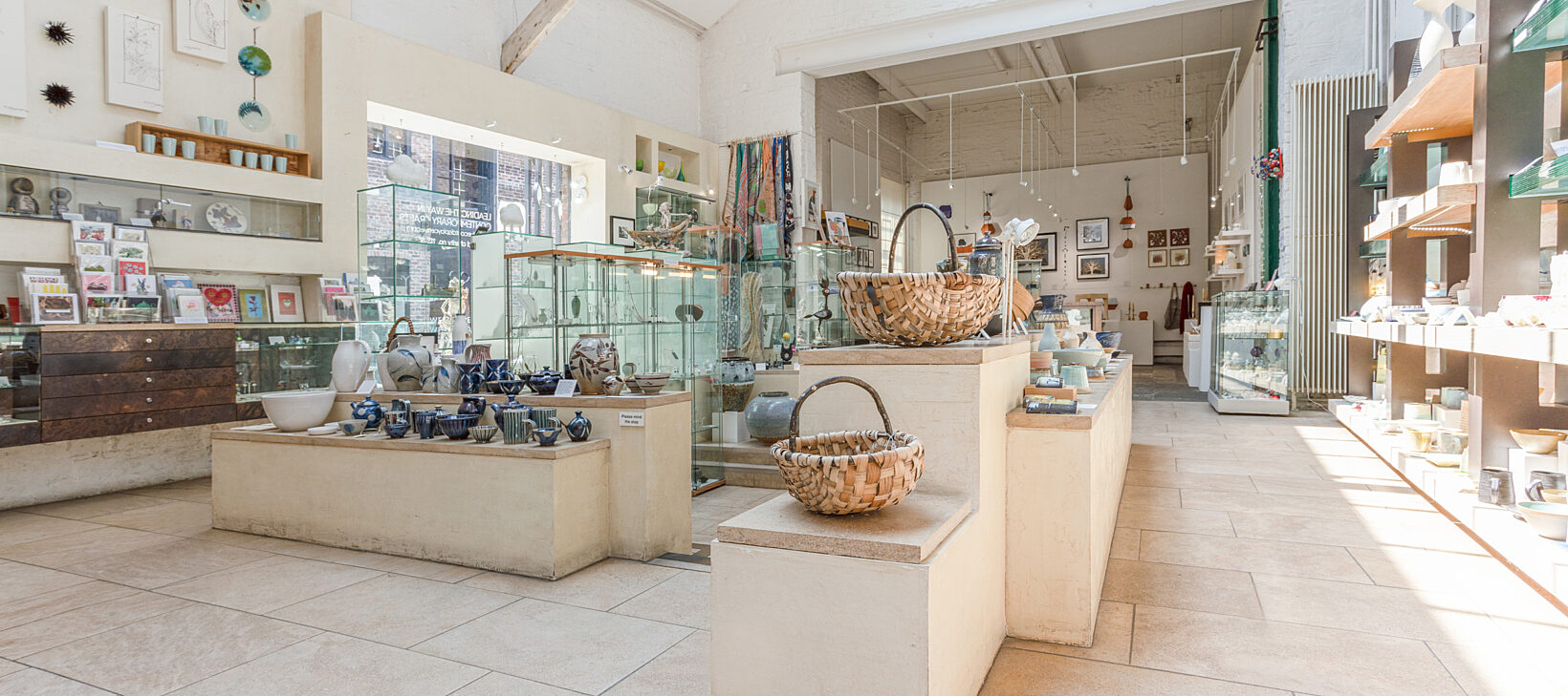 Image displays the interior of Bluecoat Display Centre shop, with shelves of various gifts.